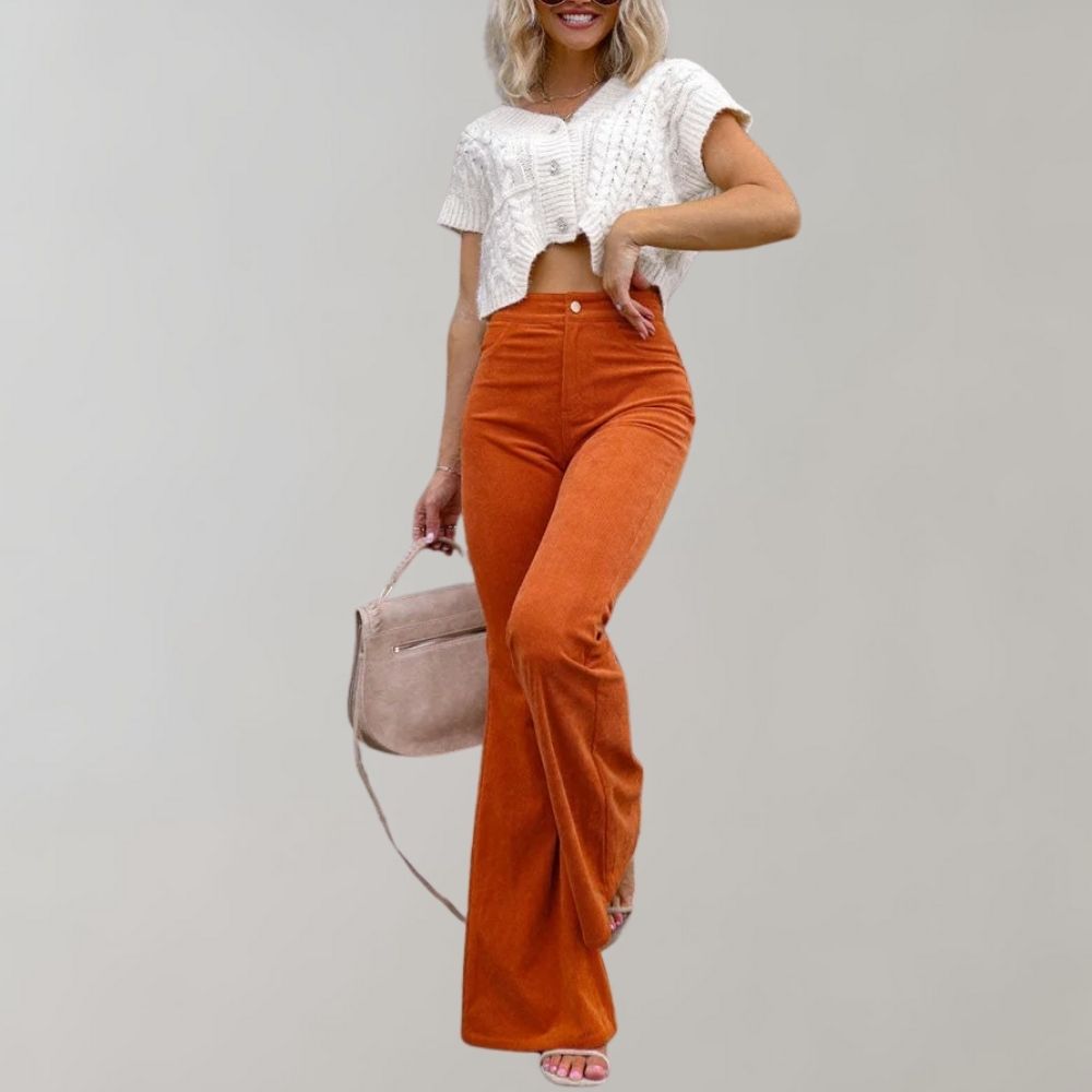 Women's high-waist flared pants paired with a cropped top, styled with a handbag and sandals, perfect for a chic and trendy look.