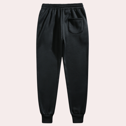 A pair of men's joggers with a relaxed fit, featuring an adjustable drawstring waistband, practical pockets, and a modern design, styled with casual sneakers.
