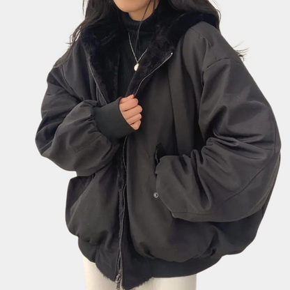 A woman wearing a cozy winter jacket with a soft and elegant design, featuring a comfortable fit and stylish details, perfect for staying warm during chilly days.