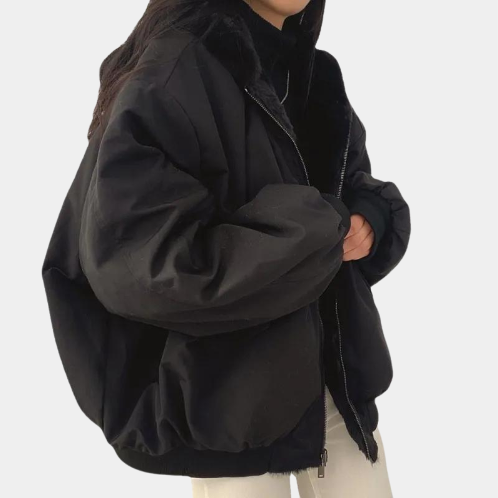 A woman wearing a cozy winter jacket with a soft and elegant design, featuring a comfortable fit and stylish details, perfect for staying warm during chilly days.