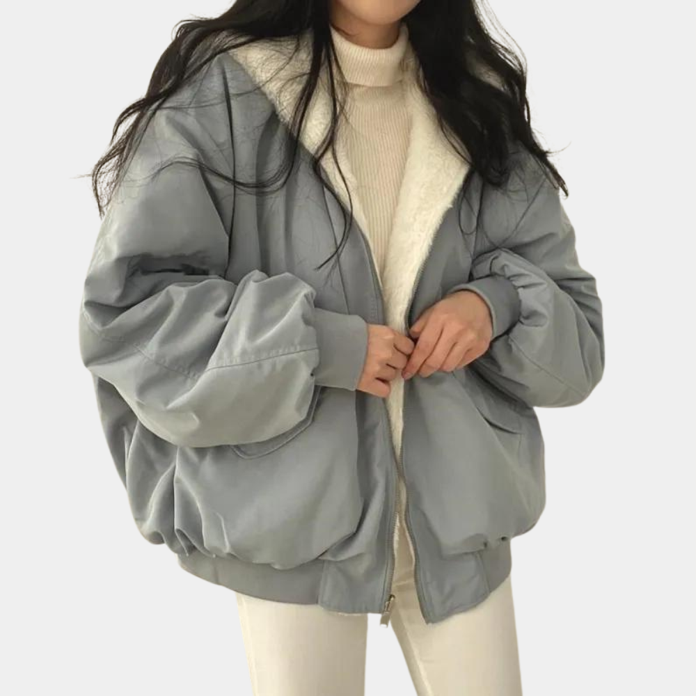 A woman wearing a cozy winter jacket with a soft and elegant design, featuring a comfortable fit and stylish details, perfect for staying warm during chilly days.