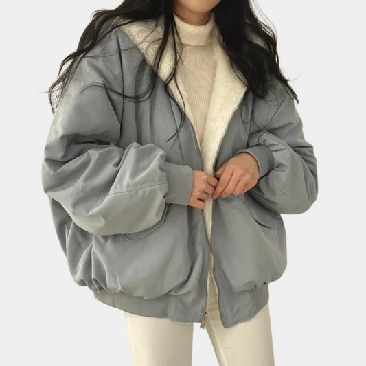 A woman wearing a cozy winter jacket with a soft and elegant design, featuring a comfortable fit and stylish details, perfect for staying warm during chilly days.