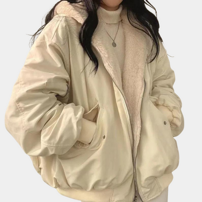 A woman wearing a cozy winter jacket with a soft and elegant design, featuring a comfortable fit and stylish details, perfect for staying warm during chilly days.