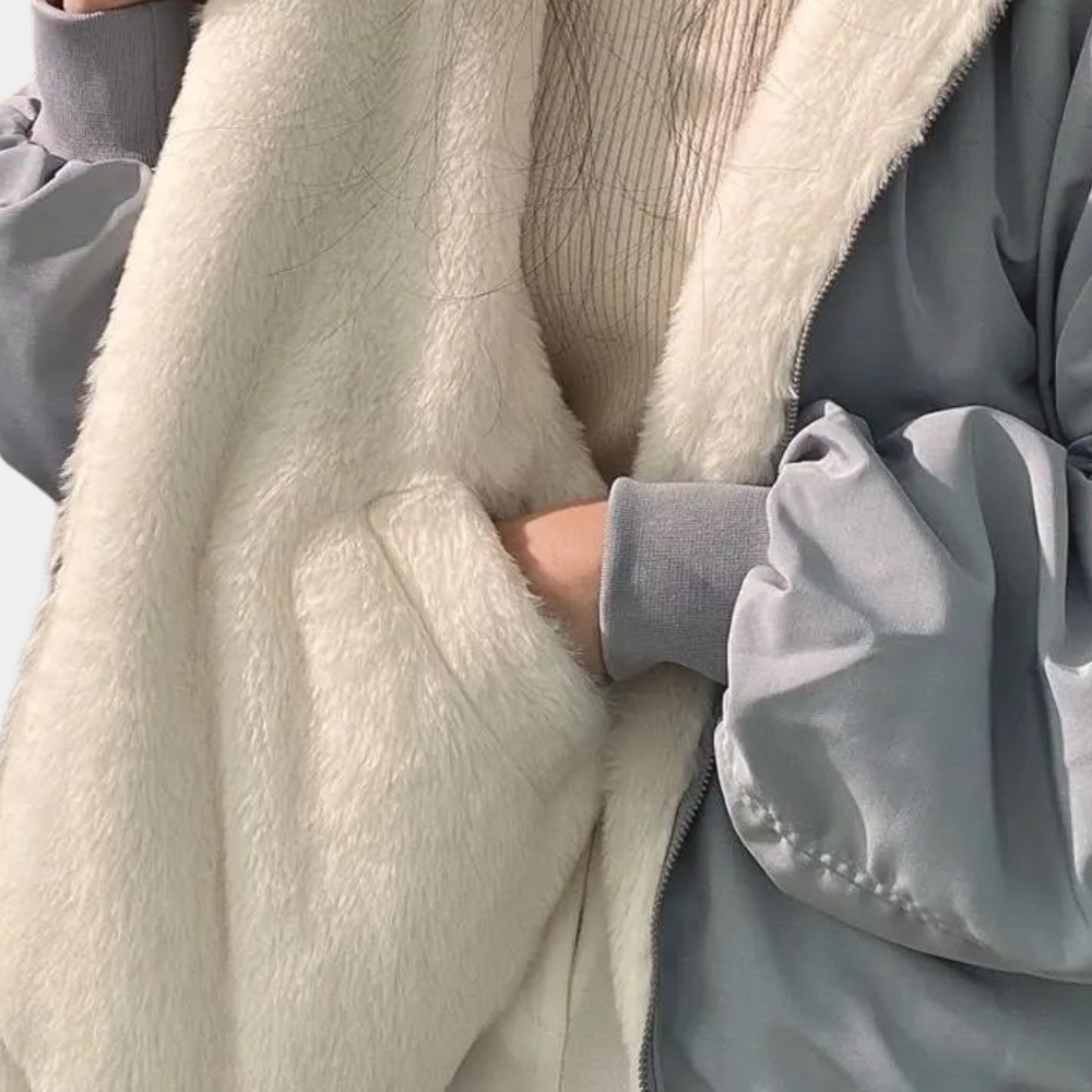 A woman wearing a cozy winter jacket with a soft and elegant design, featuring a comfortable fit and stylish details, perfect for staying warm during chilly days.
