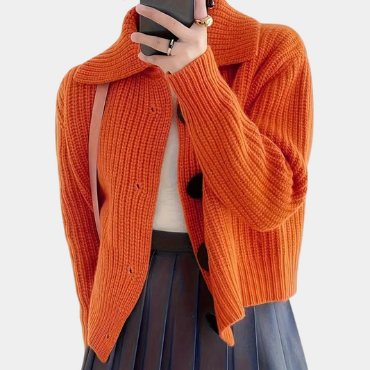 Chunky knit cardigan with oversized buttons, styled with a chic outfit for a cozy and fashionable look, perfect for layering in cooler weather.