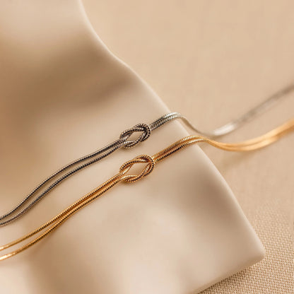 Minimalist bracelet with a sleek design displayed on a wrist, showcasing its elegant and timeless style in a cozy setting.
