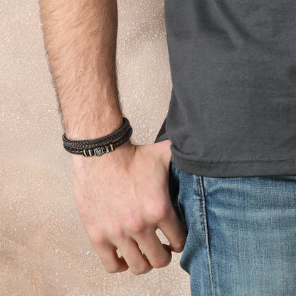 Men's multi-strand bracelet featuring a layered design with intricate details, worn on the wrist to showcase its modern and stylish appearance.