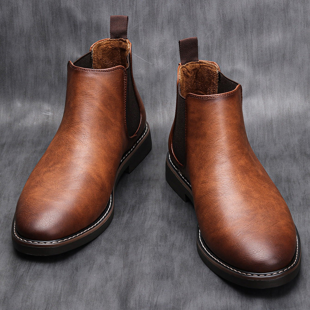 Men's ankle boots with a sleek design and durable construction, featuring a pull-tab and sturdy sole, perfect for versatile everyday wear.