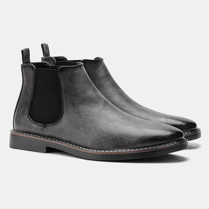 Men's ankle boots with a sleek design and durable construction, featuring a pull-tab and sturdy sole, perfect for versatile everyday wear.