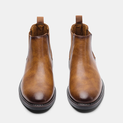 Men's ankle boots with a sleek design and durable construction, featuring a pull-tab and sturdy sole, perfect for versatile everyday wear.
