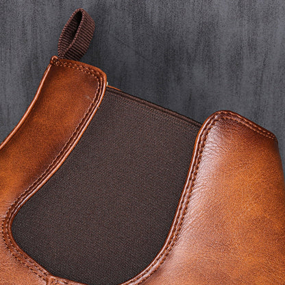 Men's ankle boots with a sleek design and durable construction, featuring a pull-tab and sturdy sole, perfect for versatile everyday wear.