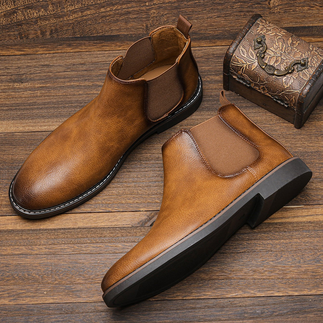 Men's ankle boots with a sleek design and durable construction, featuring a pull-tab and sturdy sole, perfect for versatile everyday wear.
