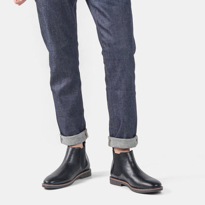 Men's ankle boots with a sleek design and durable construction, featuring a pull-tab and sturdy sole, perfect for versatile everyday wear.