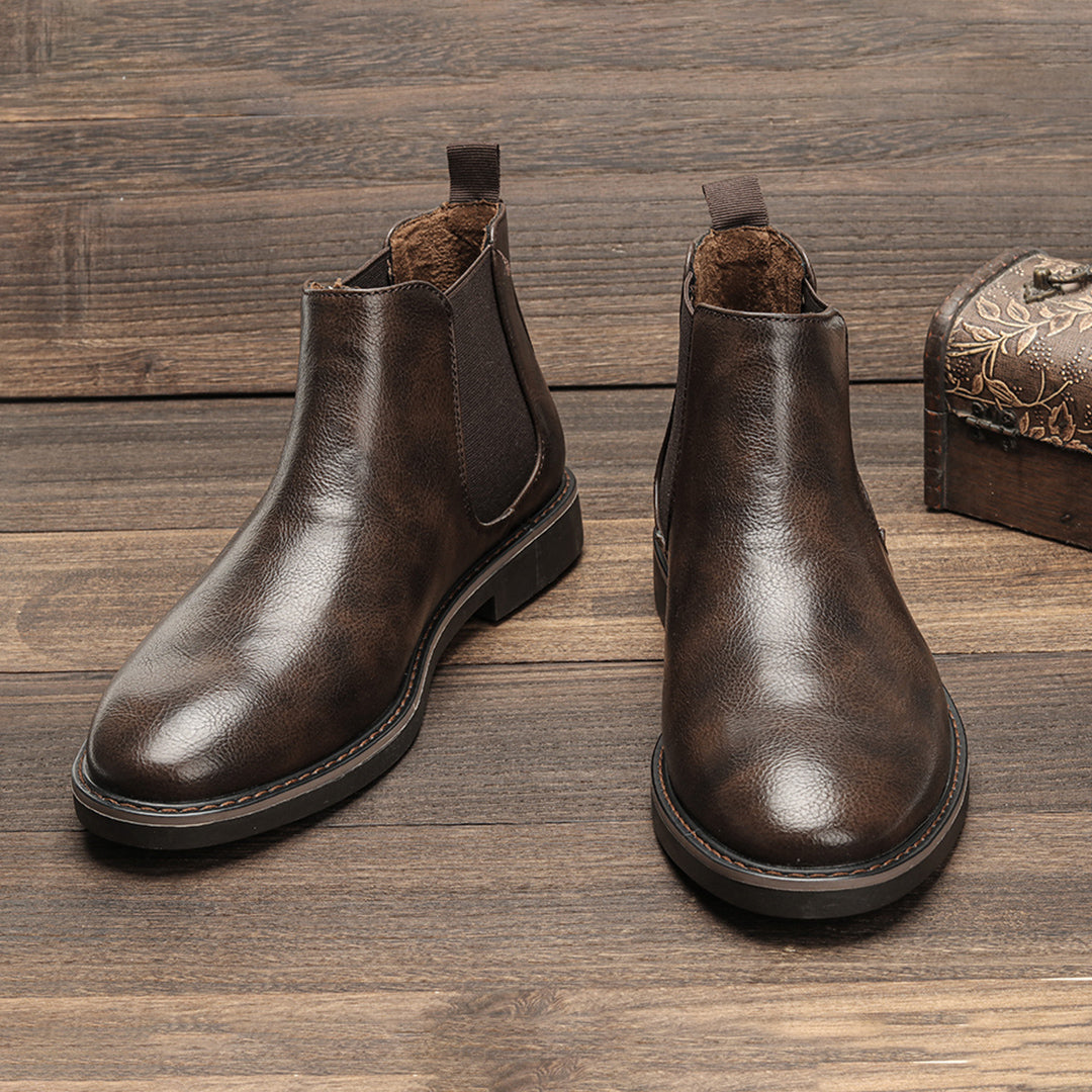 Men's ankle boots with a sleek design and durable construction, featuring a pull-tab and sturdy sole, perfect for versatile everyday wear.