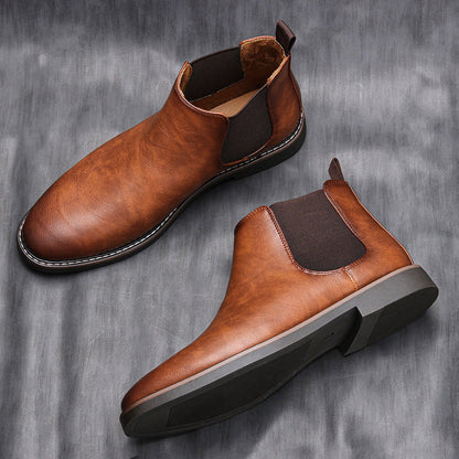 Men's ankle boots with a sleek design and durable construction, featuring a pull-tab and sturdy sole, perfect for versatile everyday wear.