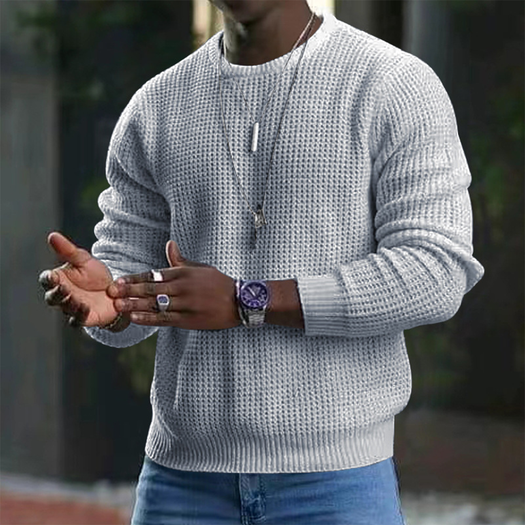 A stylish men's textured sweater featuring a modern design, paired with casual jeans and accessories. Perfect for a sleek and comfortable look suitable for both casual outings and smart occasions.
