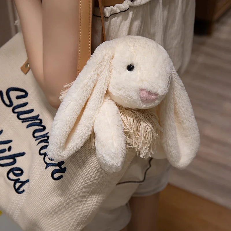 A plush bunny toy with a soft, huggable design, featuring long floppy ears and a charming appearance, perfect for cuddling, playtime, or gifting to loved ones.