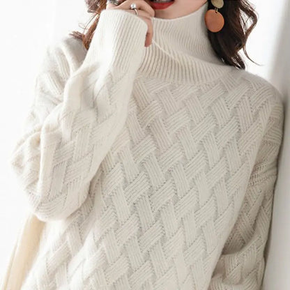 Close-up of a cozy textured knit sweater with a turtleneck design, highlighting the intricate pattern and soft material, perfect for a stylish and warm look.