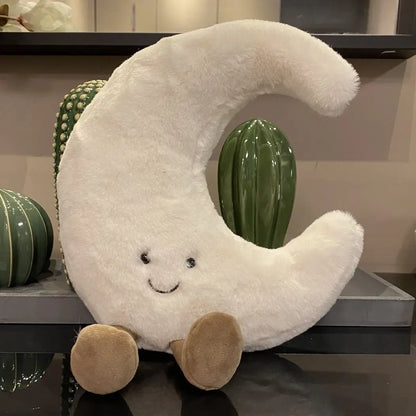 A plush set featuring a cheerful sun and a crescent moon with adorable smiling faces and soft, huggable designs, perfect for snuggles, room decor, or gifting.