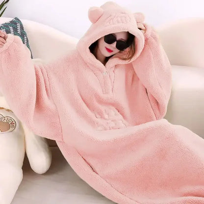 A cozy hooded blanket with an oversized design, featuring soft plush material and playful ear details on the hood, perfect for lounging at home and staying warm in style.