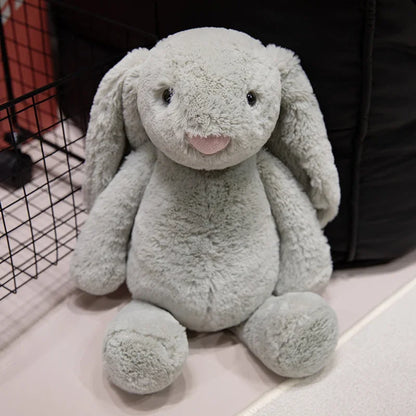 A plush bunny toy with a soft, huggable design, featuring long floppy ears and a charming appearance, perfect for cuddling, playtime, or gifting to loved ones.