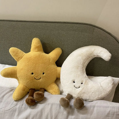 A plush set featuring a cheerful sun and a crescent moon with adorable smiling faces and soft, huggable designs, perfect for snuggles, room decor, or gifting.