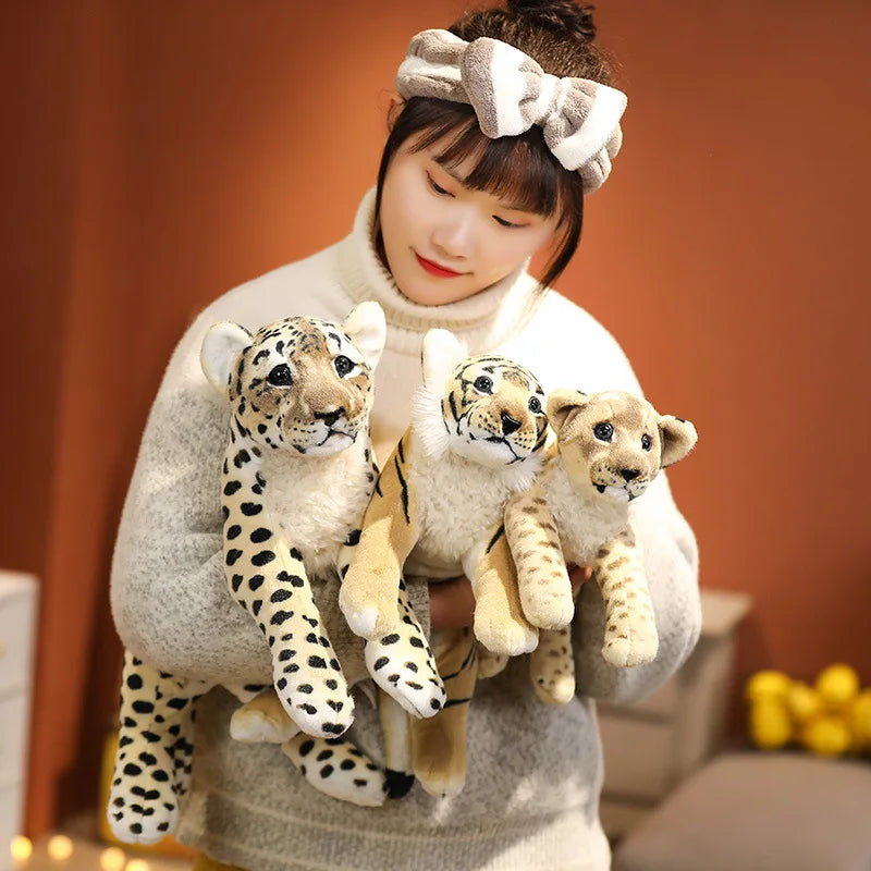 Three adorable plush animal toys featuring lifelike designs of wild animals, displayed on a wooden surface. Perfect for play, decor, or as a cuddly companion.