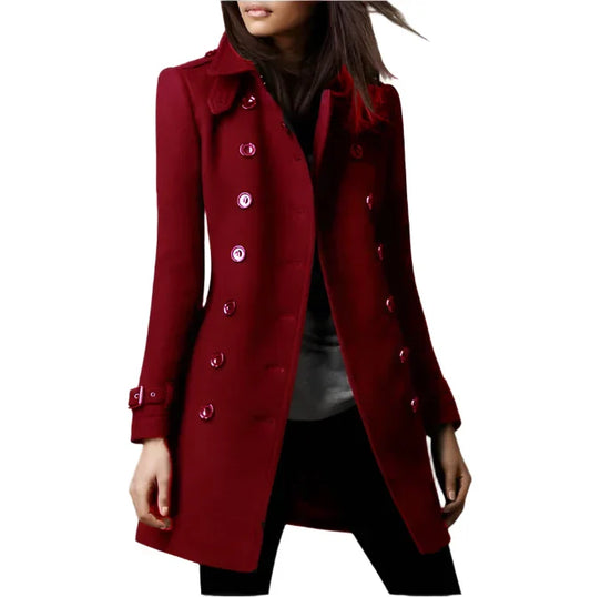 A woman wearing a stylish double-breasted coat with a sophisticated design, featuring a tailored fit and elegant button details, perfect for formal occasions or everyday wear.