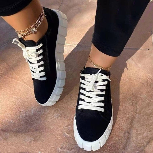 A stylish pair of women's chunky sole sneakers featuring a modern design, held in hand to showcase the bold sole and sleek details, perfect for casual or athleisure wear.