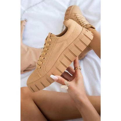 A stylish pair of women's chunky sole sneakers featuring a modern design, held in hand to showcase the bold sole and sleek details, perfect for casual or athleisure wear.