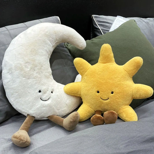 A plush set featuring a cheerful sun and a crescent moon with adorable smiling faces and soft, huggable designs, perfect for snuggles, room decor, or gifting.