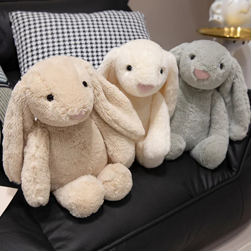 A plush bunny toy with a soft, huggable design, featuring long floppy ears and a charming appearance, perfect for cuddling, playtime, or gifting to loved ones.