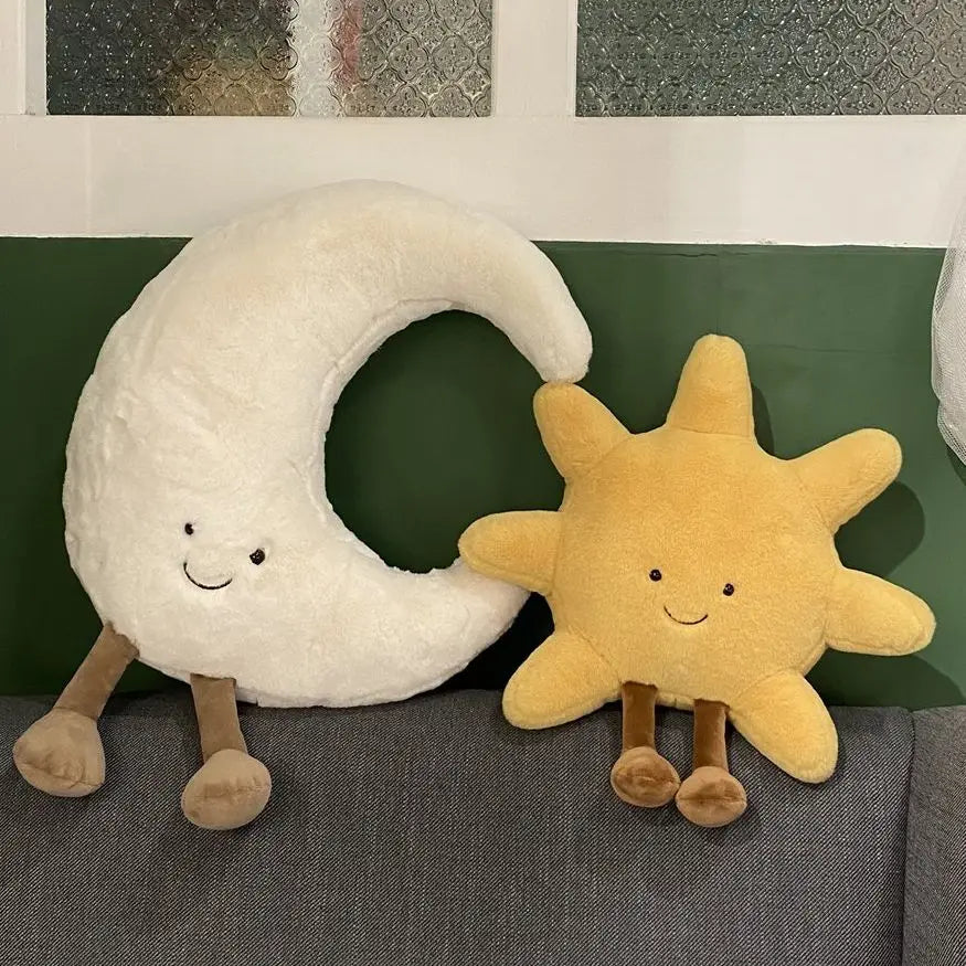 A plush set featuring a cheerful sun and a crescent moon with adorable smiling faces and soft, huggable designs, perfect for snuggles, room decor, or gifting.