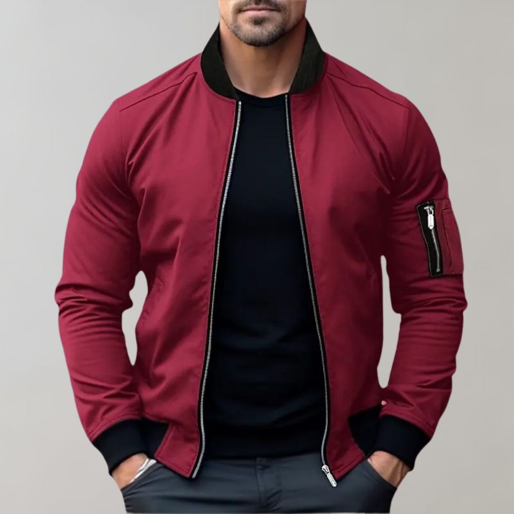 Men's sleek bomber jacket with a modern design, featuring a zip-up front, ribbed cuffs, and a zippered sleeve pocket, styled with a casual outfit for a contemporary look.