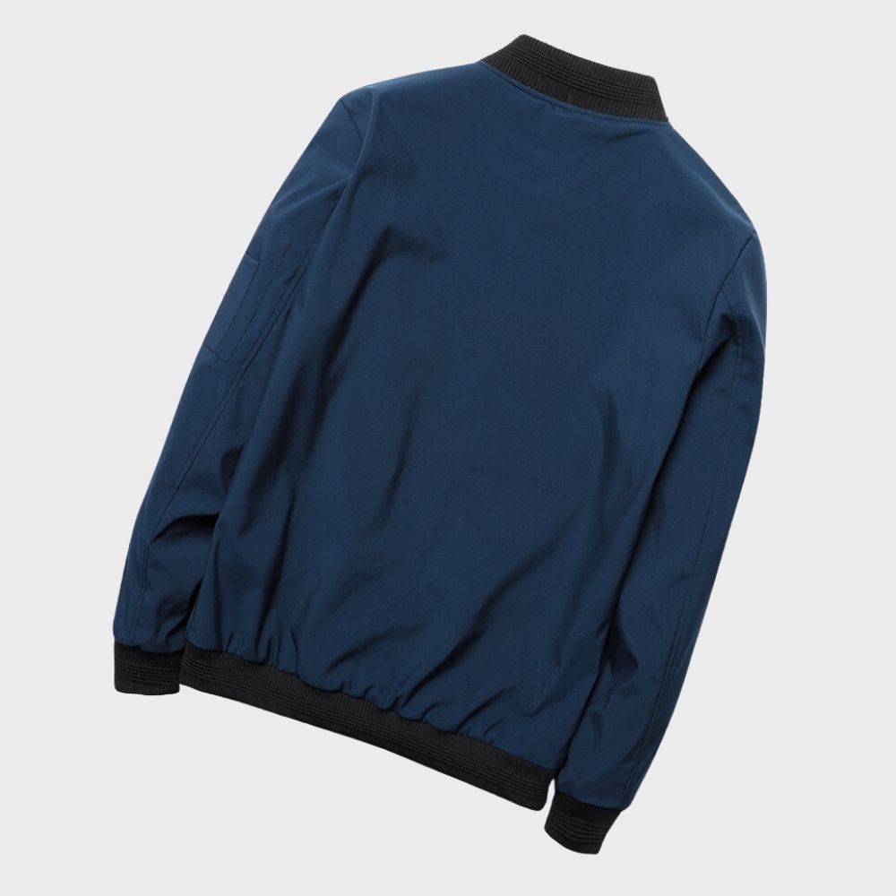 Men's sleek bomber jacket with a modern design, featuring a zip-up front, ribbed cuffs, and a zippered sleeve pocket, styled with a casual outfit for a contemporary look.