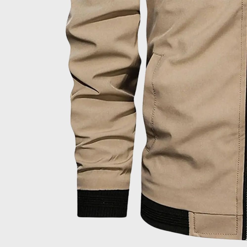 Men's sleek bomber jacket with a modern design, featuring a zip-up front, ribbed cuffs, and a zippered sleeve pocket, styled with a casual outfit for a contemporary look.