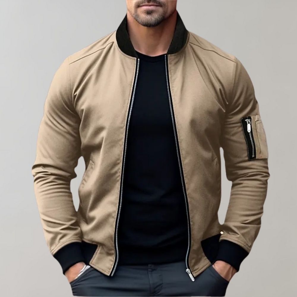 Men's sleek bomber jacket with a modern design, featuring a zip-up front, ribbed cuffs, and a zippered sleeve pocket, styled with a casual outfit for a contemporary look.