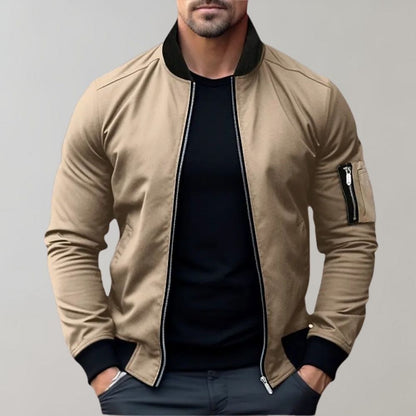 Men's sleek bomber jacket with a modern design, featuring a zip-up front, ribbed cuffs, and a zippered sleeve pocket, styled with a casual outfit for a contemporary look.