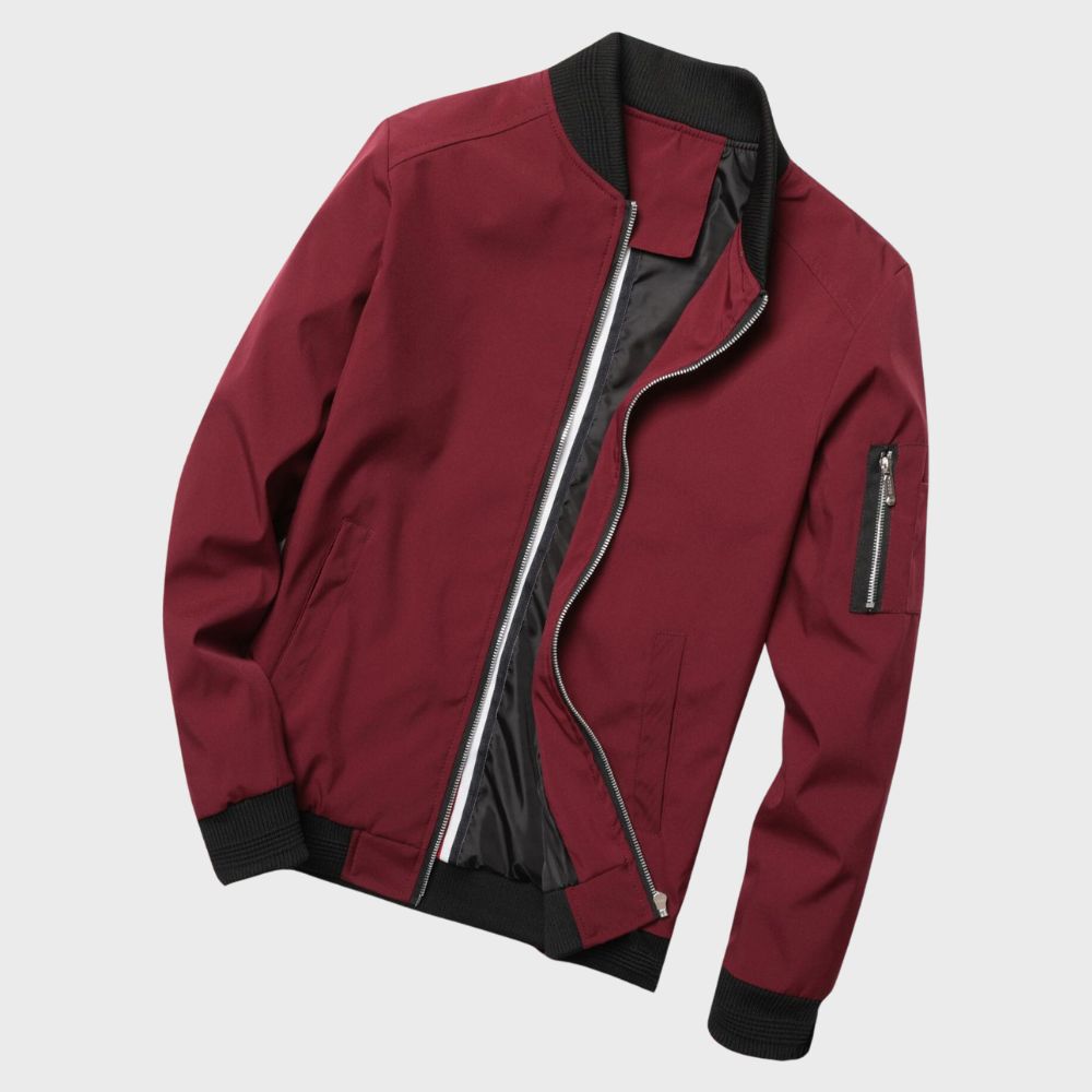 Men's sleek bomber jacket with a modern design, featuring a zip-up front, ribbed cuffs, and a zippered sleeve pocket, styled with a casual outfit for a contemporary look.