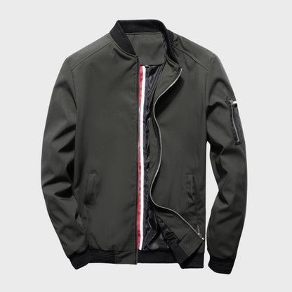 Men's sleek bomber jacket with a modern design, featuring a zip-up front, ribbed cuffs, and a zippered sleeve pocket, styled with a casual outfit for a contemporary look.