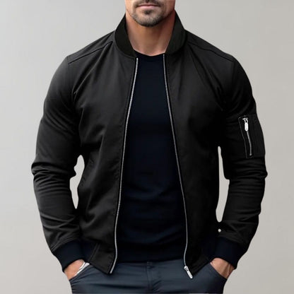 Men's sleek bomber jacket with a modern design, featuring a zip-up front, ribbed cuffs, and a zippered sleeve pocket, styled with a casual outfit for a contemporary look.