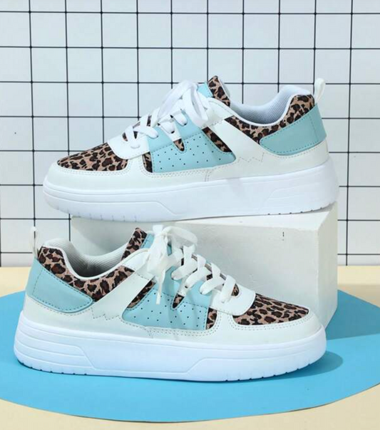 Stylish women's casual sneakers featuring a trendy design, displayed on a minimalist backdrop with elevated blocks, showcasing their modern and versatile appeal.