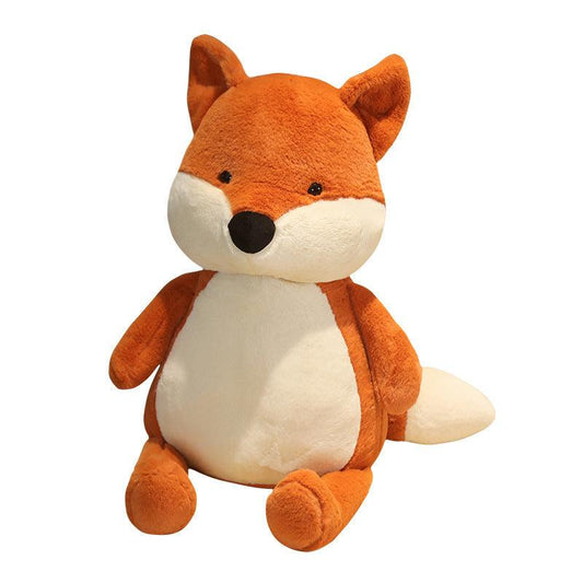 Plush toy set featuring a family of foxes in various sizes, arranged on a cozy bed in a warm and inviting room setting.