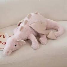 A plush dragon toy featuring a whimsical design with detailed wings and a soft, huggable texture, perfect for playtime, snuggles, or as a unique gift for all ages.