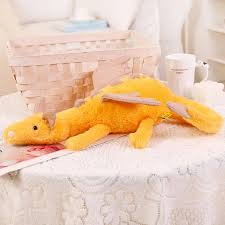 A plush dragon toy featuring a whimsical design with detailed wings and a soft, huggable texture, perfect for playtime, snuggles, or as a unique gift for all ages.