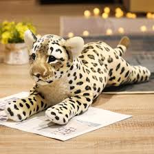 Three adorable plush animal toys featuring lifelike designs of wild animals, displayed on a wooden surface. Perfect for play, decor, or as a cuddly companion.