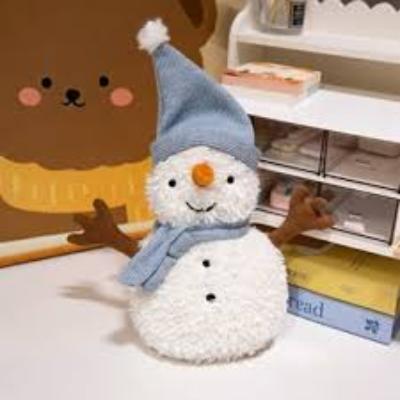 A soft and adorable plush snowman toy with button details and outstretched arms, placed on a cozy setting perfect for holiday decoration or gifting.