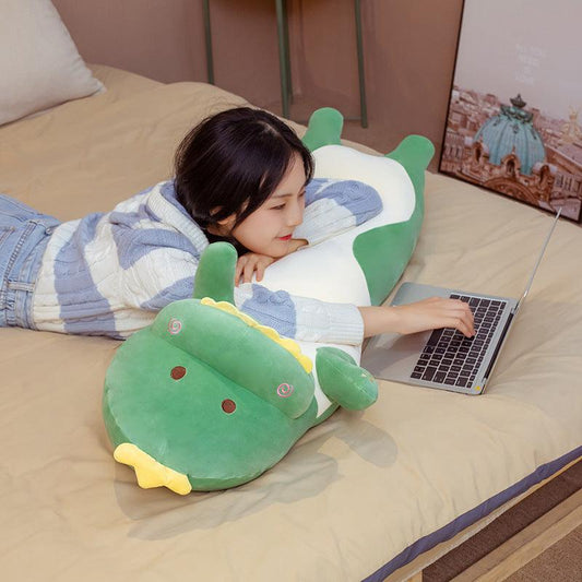 A plush body pillow featuring a playful dinosaur design, with a soft and huggable texture, perfect for snuggling, decorating, or gifting to all ages.
