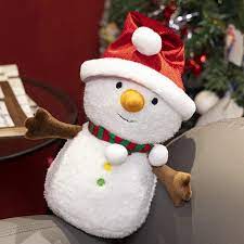 A soft and adorable plush snowman toy with button details and outstretched arms, placed on a cozy setting perfect for holiday decoration or gifting.