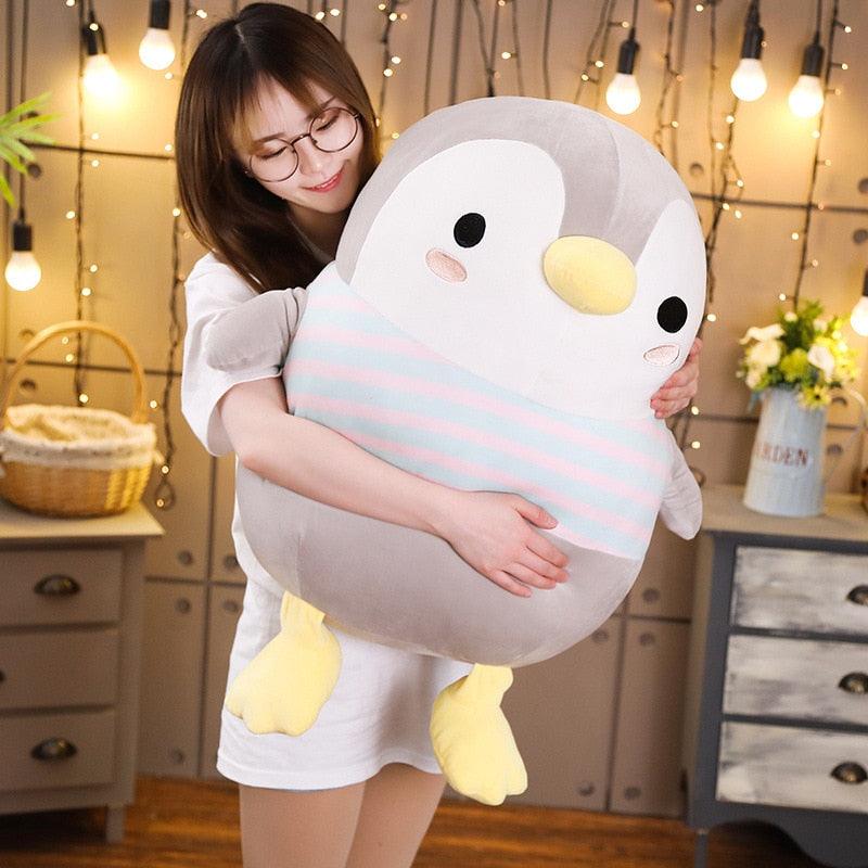 A large plush penguin toy with a soft, huggable design, perfect for cuddling or as a playful companion for all ages. Ideal for gifting or adding charm to any room.